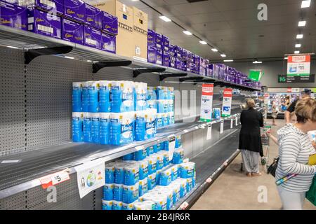 Coronavirus in Australia leads to mass panic buying of toilet rolls toilet paper leaving supermarkets with empty shelves and need to restrict purchase Stock Photo