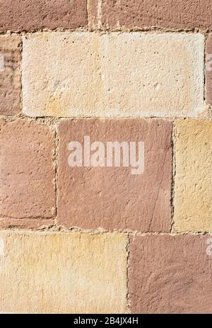 sandstone block wall in red and yellow shades for background Stock Photo