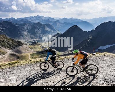 Mountain biking on the Pic du Midi de Bigorre (2877m) in the French High Pyrenees. Two male mountain bikers during the descent on singletrack. Stock Photo