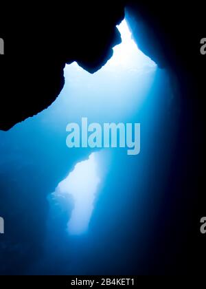 Light shines through underwater lava caves in Hawaii. Stock Photo