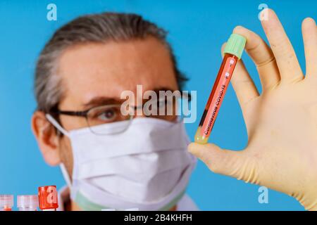 COVID-19 coronavirus atypical pneumonia, virus definition Middle East Respiratory Syndrome Blood test doctor in face mask Stock Photo