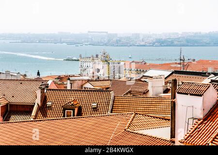 Europe, Portugal, capital city, old town of Lisbon, viewpoint, view of the Rio Tagus and the port, house roofs and the triumphal arch Stock Photo
