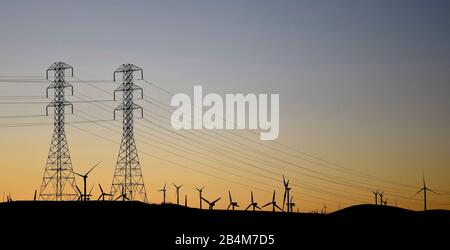 electric power towers, lines and wind power turbines in California Stock Photo