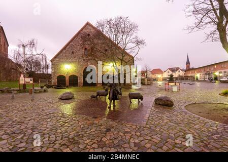 Germany, Saxony-Anhalt, Wolmirstedt, castle domain, castle complex from the Middle Ages, with shepherd sculpture in the foreground. Stock Photo