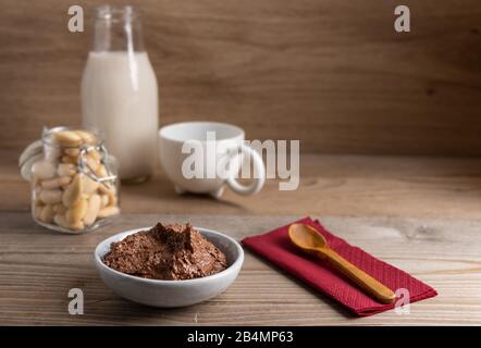 Homemade vegan chocolate spread in a small bowl made of almond butter,cacao and honey. Stock Photo