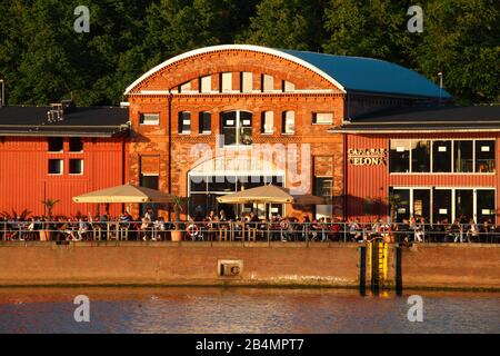 Cafe Bar Celona in an old harbor shed on the banks of the Trave, Lübeck, Schleswig-Holstein, Germany, Europe Stock Photo