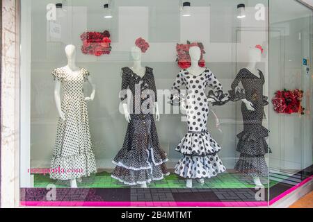 One day in Malaga; Impressions from this city in Andalusia, Spain. Flamenco dresses in the window of a fashion store