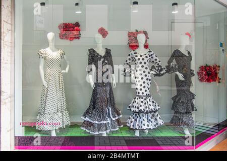 One day in Malaga; Impressions from this city in Andalusia, Spain. Flamenco dresses in the window of a fashion store Stock Photo