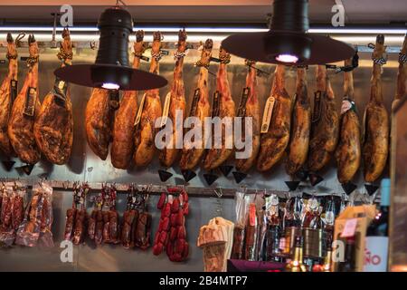 One day in Malaga; Impressions from this city in Andalusia, Spain. Butcher shop with ham. Stock Photo