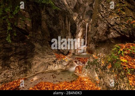 A small stream on the Kesselberg near Kochel am See with a breakthrough in the rock and waterfall in autumn. Stock Photo