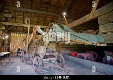 Old agricultural equipment,  machinery and combine harvester in the farmer barn house Stock Photo