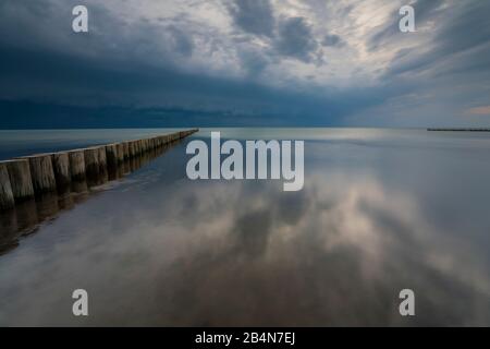 Baltic Sea in the evening light, long exposure, setting sun, dark clouds, a low pressure area is on the way Stock Photo