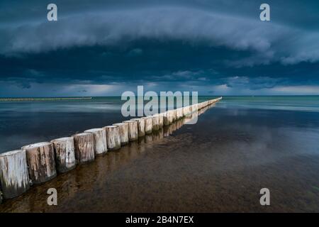 Baltic Sea in the evening light, long exposure, setting sun, dark clouds, a low pressure area is on the way Stock Photo