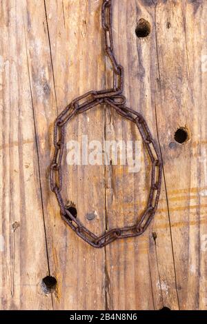 a rusted metal chain on wooden background Stock Photo