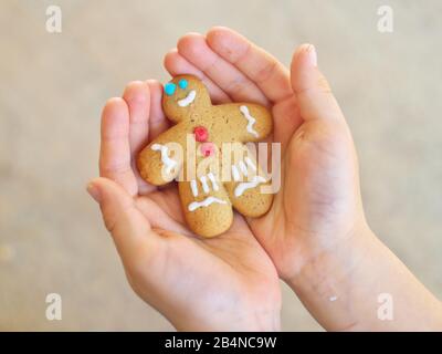 Gingerbread cookies man in child hands Stock Photo