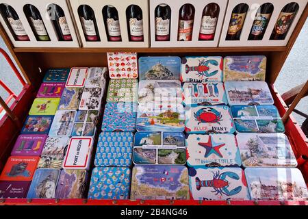 Cider or colorful tin cans with motifs for sale as souvenirs. Port-en-Bessin-Huppain is a commune in the Calvados department in the Normandy region in France. Stock Photo