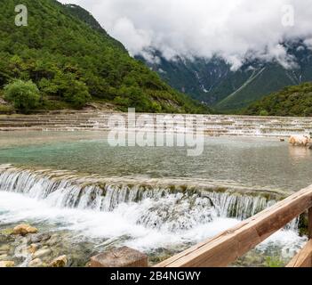 Emerald color  waterfalls at Blue Moon Valley at the foot of Jade Dragon Snow Mnt (Yulong Xue Shan) in Lijiang, Yunnan Province, China. Stock Photo