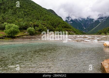 Cascades at Blue Moon Valley at the foot of Jade Dragon Snow Mnt (Yulong Xue Shan) in Lijiang, Yunnan Province, China. Stock Photo