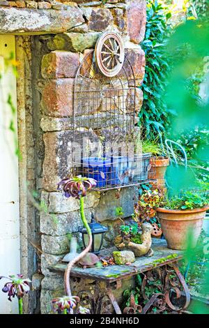 Colorful decorations on a stone house wall. In the Cote des Bruyeres region in the Finistère department. Stock Photo