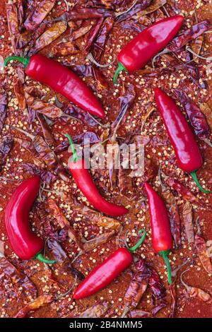 Red Chilli peppers with dried red chillies and chilli flakes and powder Stock Photo