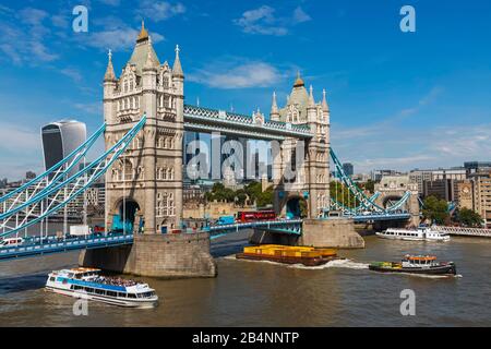 England, London, Tower Bridge and City of London Skyline with Various River Traffic Passing By Stock Photo