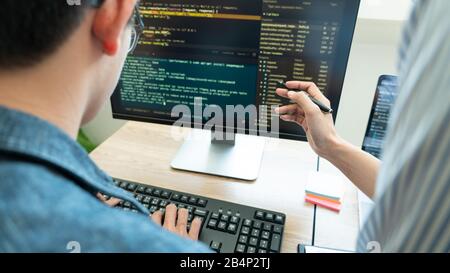 Collaborative work Software engineers website developer technologies or programmer working coding on startup ai application project on screen with par Stock Photo