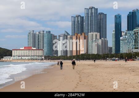 Busan, South Korea - March 17, 2018: Haeundae beach landscape, one of the most famous and beautiful beaches in Busan, ordinary people walk the sandy c Stock Photo