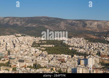 Young woman taken a picture of the city of Athens from the Mount Lycabettus a Cretaceous limestone hill Stock Photo