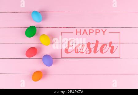 Easter Day Eggs, Decorated colorful Eggs on pink wooden table Stock Photo