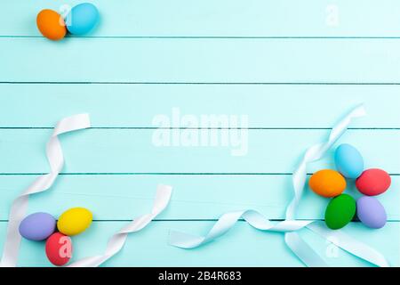 Easter Day Eggs, Decorated colorful Eggs on blue wooden table Stock Photo