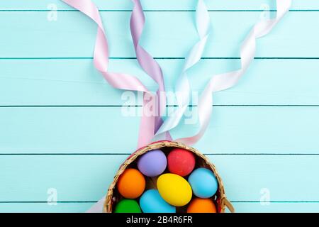 Easter Day Eggs, Decorated colorful Eggs on blue wooden table Stock Photo