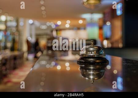 Selected focus view at Ring bell For call Service on counter   at bar in front of desk Kitchen with blur background of restaurant's atmosphere. Stock Photo