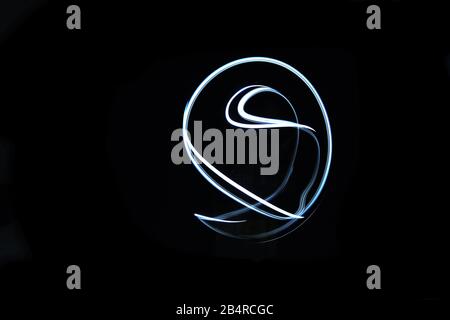 Abstract glowing light in geometric drawing isolated in black background. Stock Photo