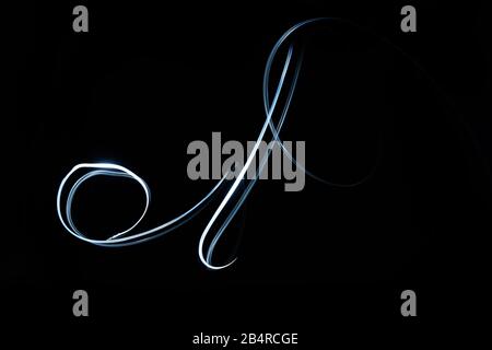 Abstract glowing light in geometric twist isolated in black background. Stock Photo