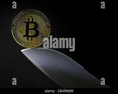 golden bitcoin coin on knife blade isolated on black background with copy space Stock Photo