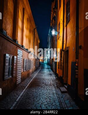 Beautiful cozy night narrow street in Gamla Stan - old town of Stockholm. 14 February 2020, Stockholm Sweden Stock Photo