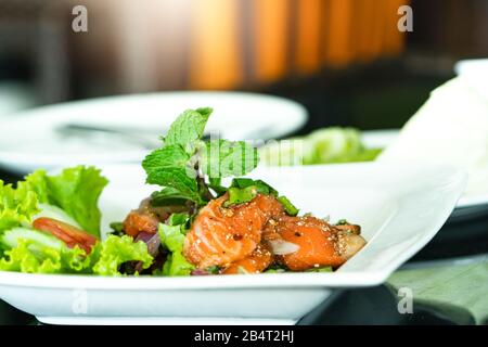 Spicy Salmon Salad with fresh mint and basil, Thai food style. Home made food. Concept for a tasty and healthy meal Stock Photo