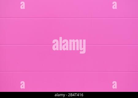 Background, texture of a pink metal wall. Close up. Stock Photo