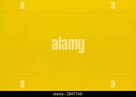 Background, texture of a yellow metal wall. Close up. Stock Photo