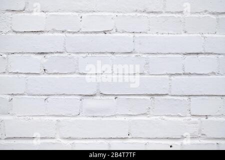 Wall of brick painted with white paint. Close up. Stock Photo