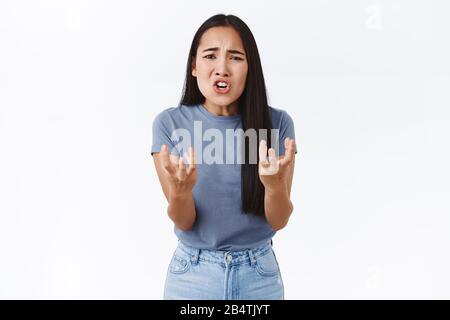 Attractive asian girlfriend breaking up as feeling tired and fed up of lies, shaking hands frustrated and confused, asking for explanation, telling Stock Photo