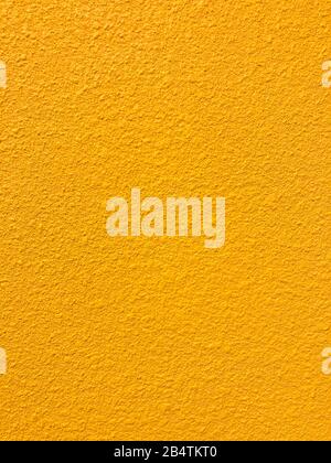 Golden yellow stone grain wall spray painted texture concrete background in retro style with copy space Stock Photo