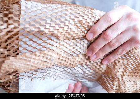 Paper packaging with a white thin layer. Parcel safety. Stock Photo