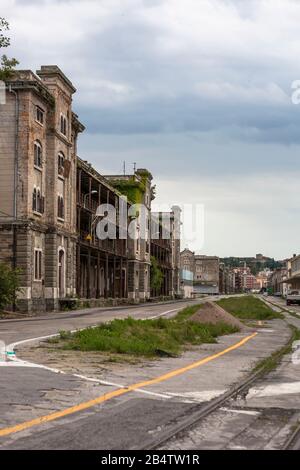 Abandoned builidings (warehouse 26 is being restored) in the Old Port of Trieste, Friuli-Venezia-Giulia, Italy Stock Photo