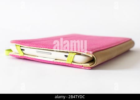 E-book reader in pink case on white background Stock Photo