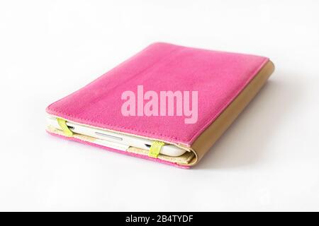 E-book reader in pink case on white background Stock Photo