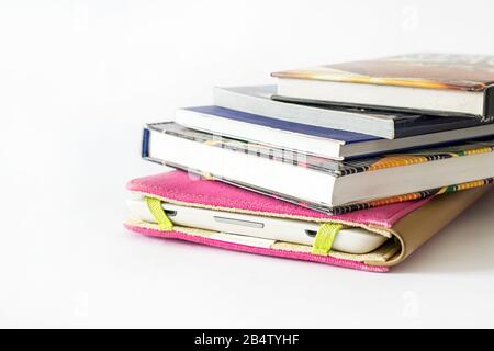 E-book reader in pink case with some old books Stock Photo
