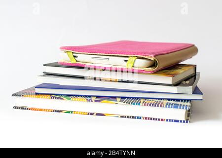 E-book reader in pink case with some old books Stock Photo