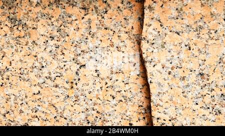 Real natural brown granite pattern, polished mineral slice. Seamless cracked marble damaged concrete texture. Architectural background. Brown spots on Stock Photo