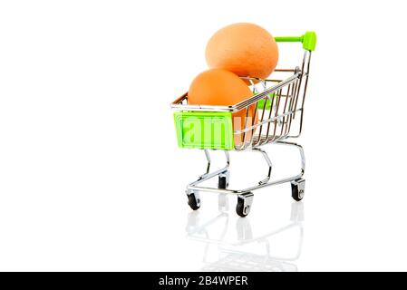 Eggs in metal shopping cart isolated on white background. Easter holiday. Stock Photo